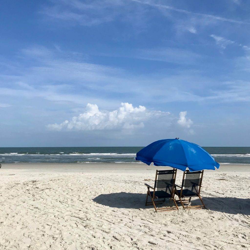 Beach chairs and umbrella for sun protection