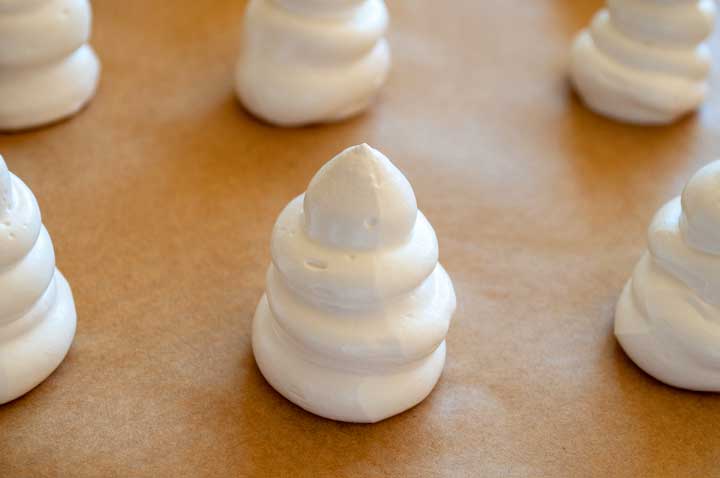 Meringues piped onto cookie sheets