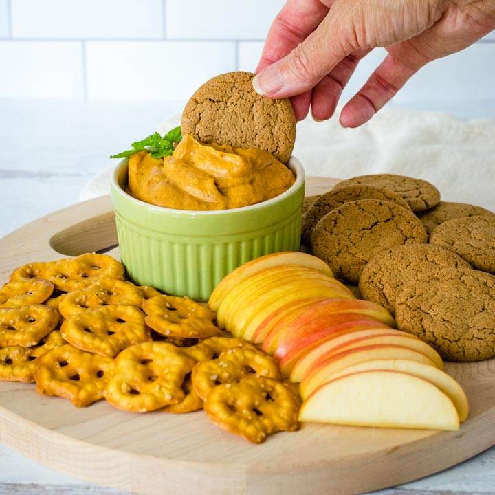 Dipping ginger snap in pumpkin dip