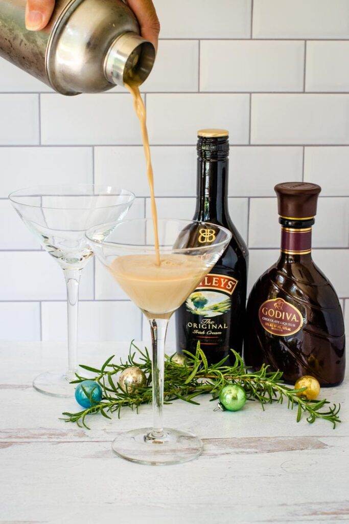 Chocolate cocktail pouring into martini glass