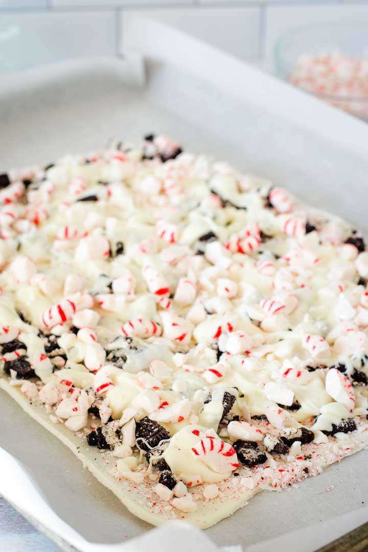 White chocolate cookie peppermint bark on baking sheet