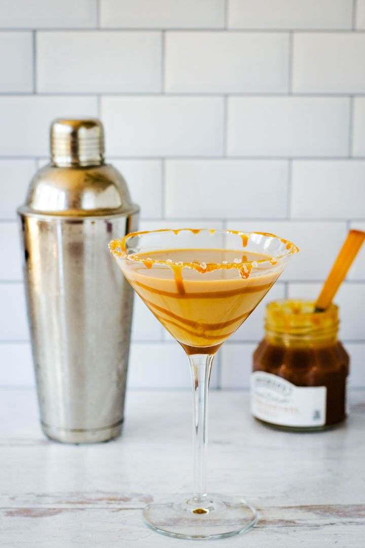 Salted caramel martini with cocktail shaker and jar of caramel.