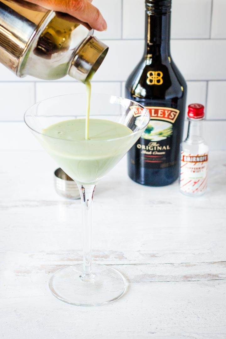 Shamrock cocktail pouring into martini glass