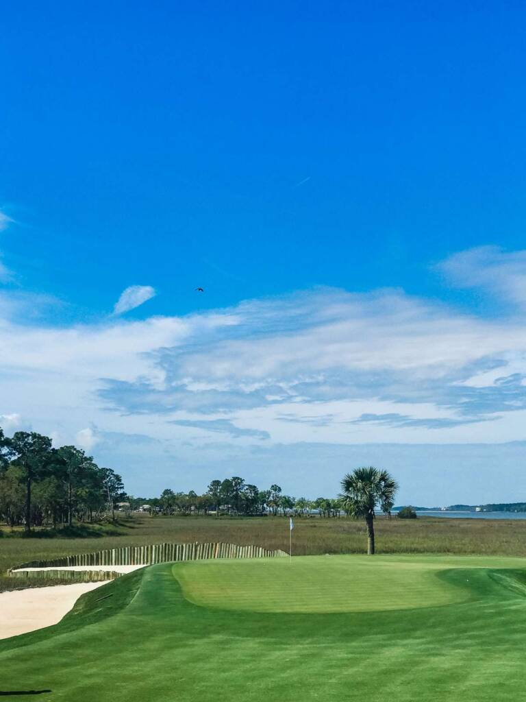 Golf course green overlooking water