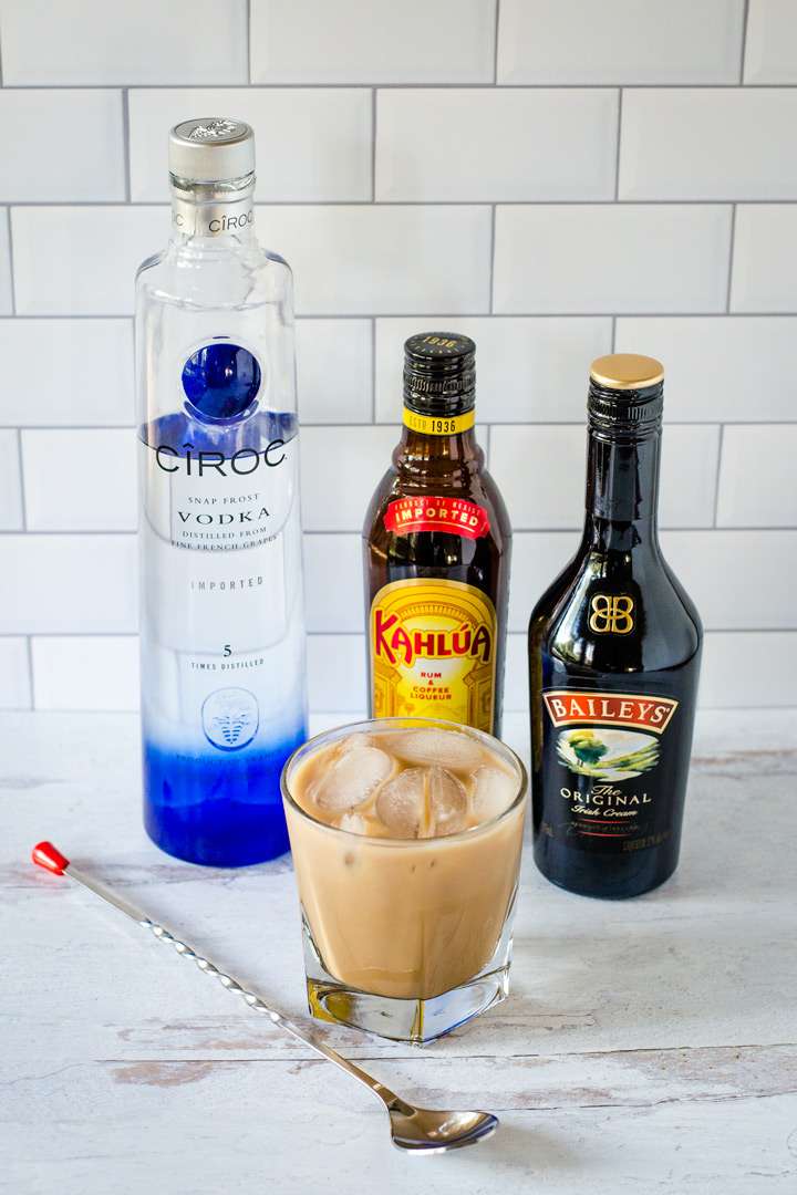 Vodka, Kahlua, Baileys, white Russian on the rocks, cocktail stirrer