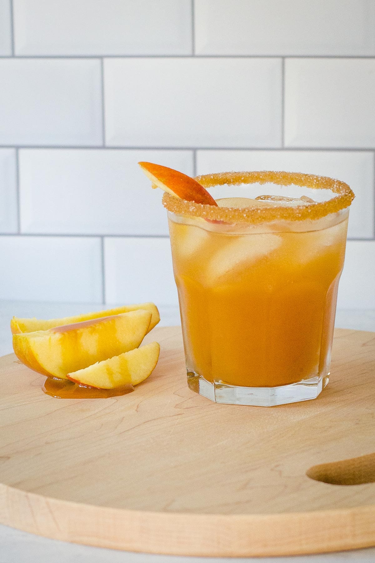 Apple cider vodka cocktail with sliced apples and caramel sauce