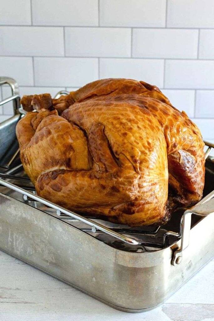 Smoked turkey on rack in pan