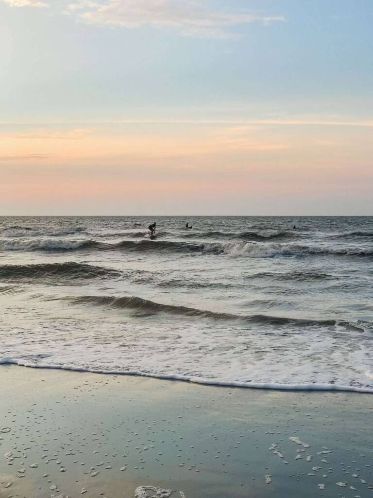 Surfers at sunrise