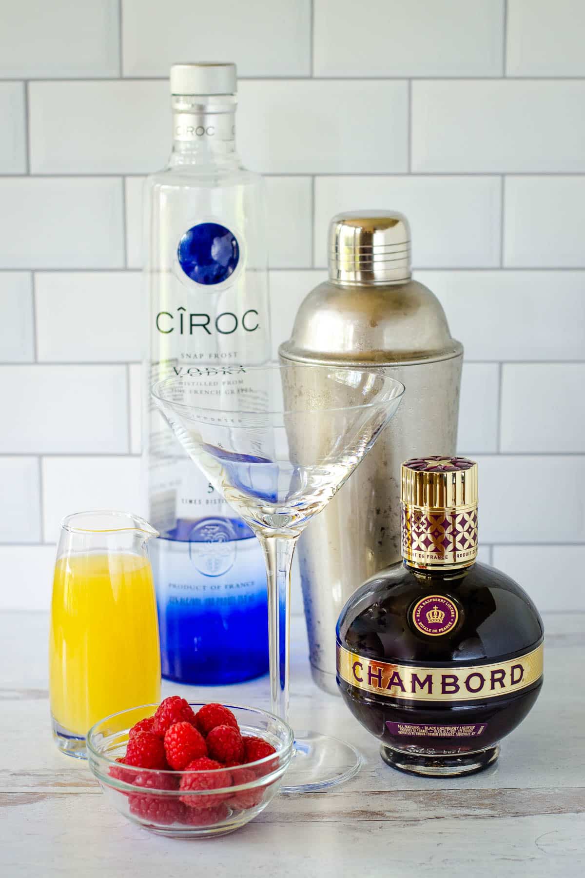 Vodka, cocktail shaker, Chambord liqueur, pineapple juice, martini glass, raspberries