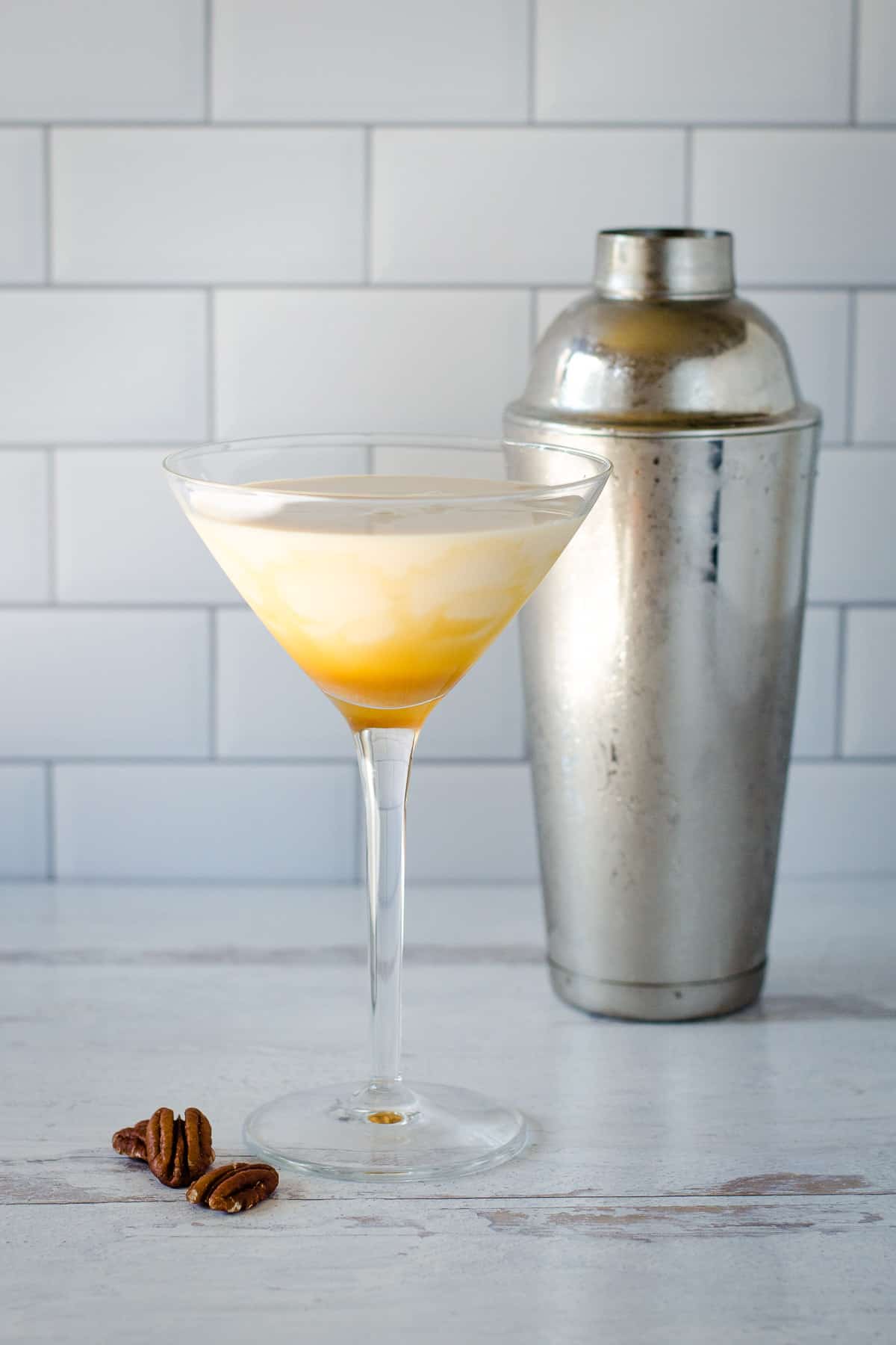 Pecan pie martini with shaker and pecans.