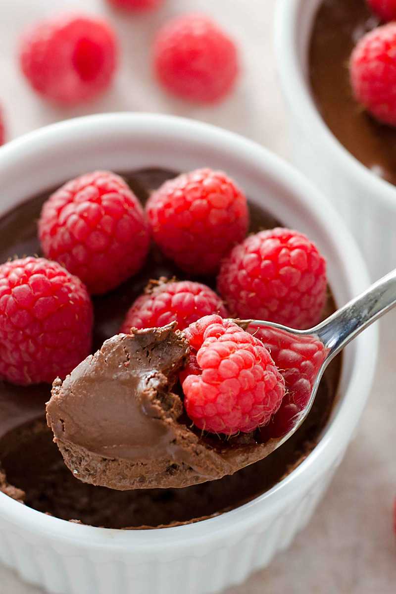 Chocolate pots de creme with fresh raspberries.