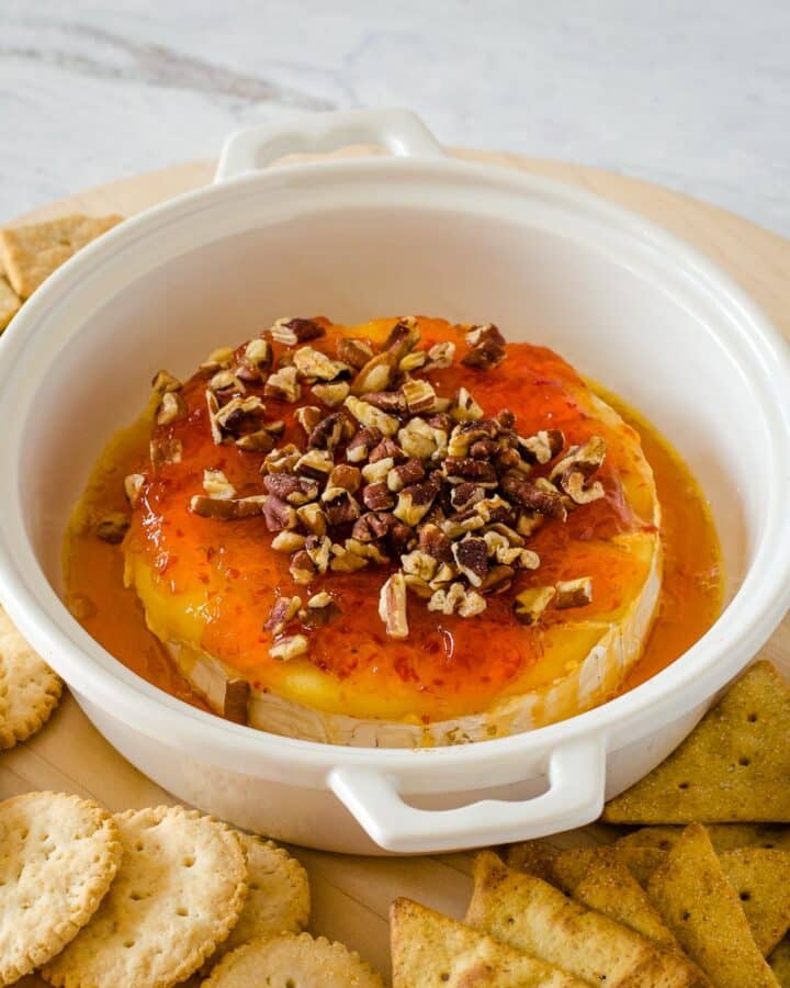 Baked brie with pepper jelly and pecans with crackers