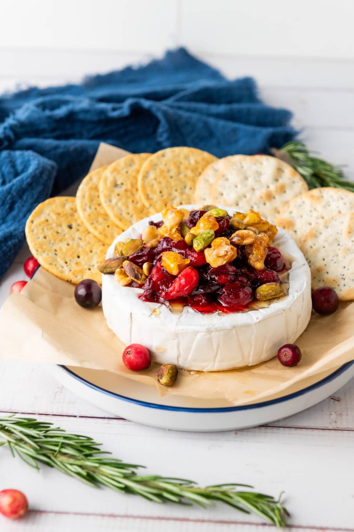 Baked cranberry brie with nuts and crackers.