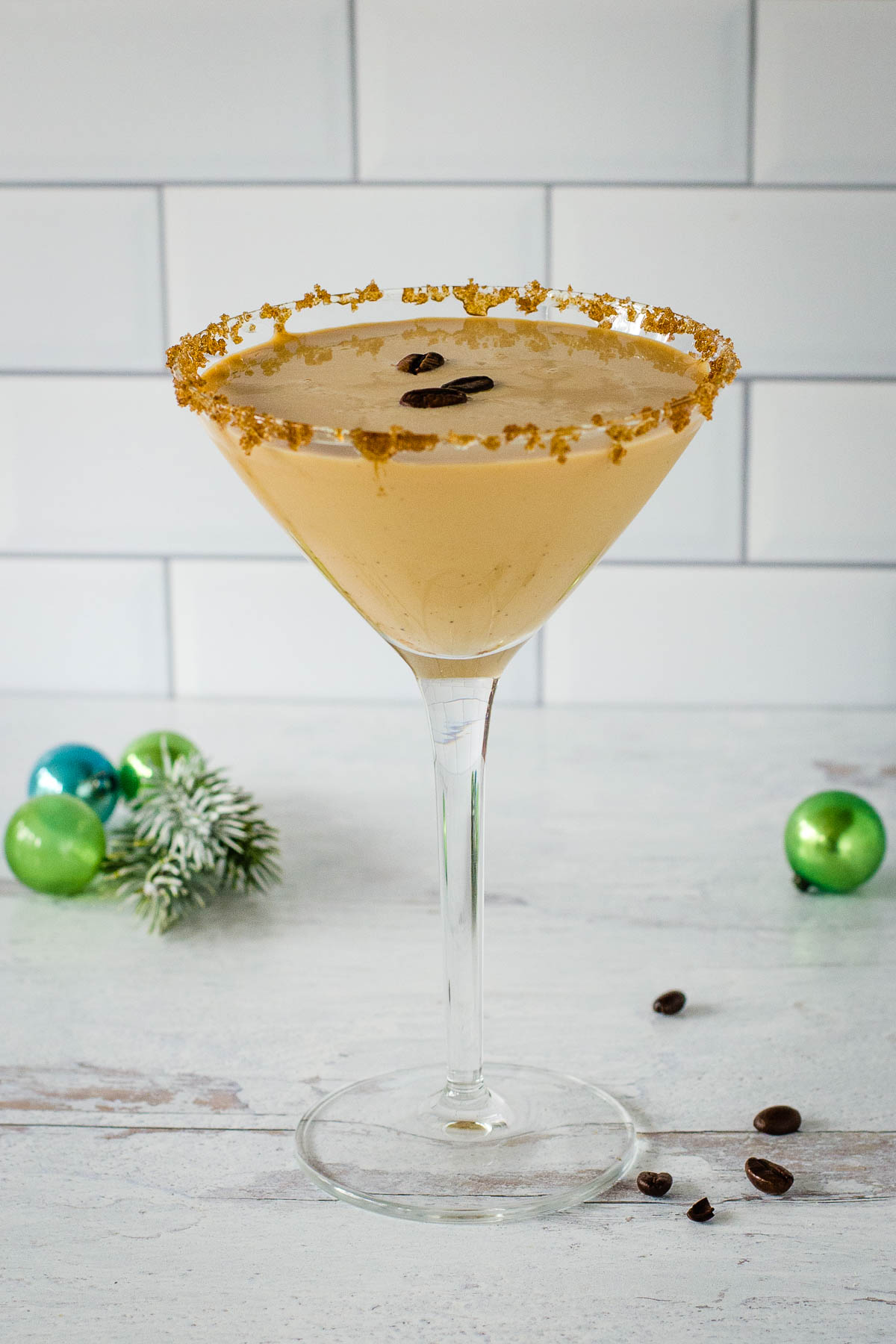 Eggnog espresso martini with Christmas ornaments.