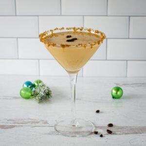 Eggnog espresso martini with Christmas ornaments.