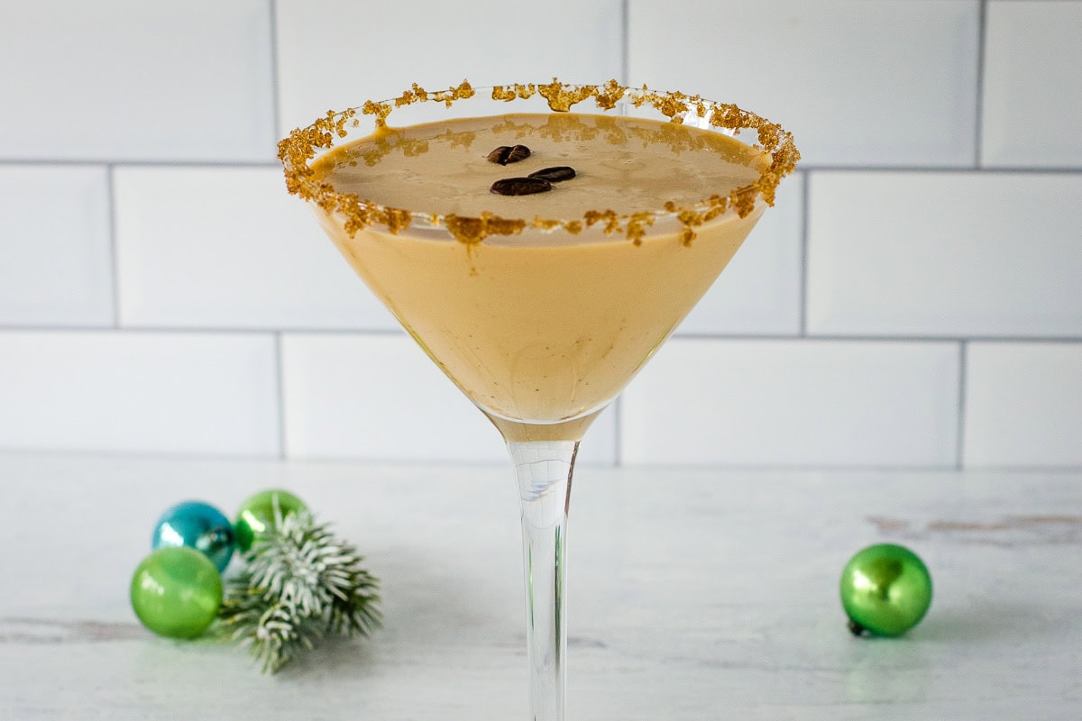 Eggnog espresso martini with Christmas ornaments.