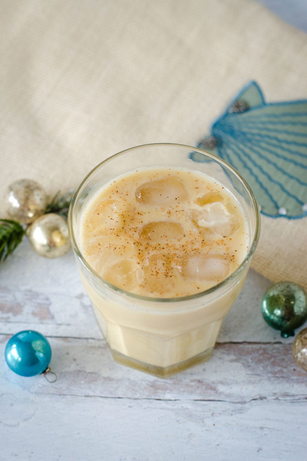 Eggnog white Russian cocktail with Christmas decorations.