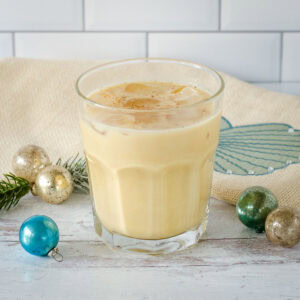 Eggnog white Russian cocktail with Christmas decorations.