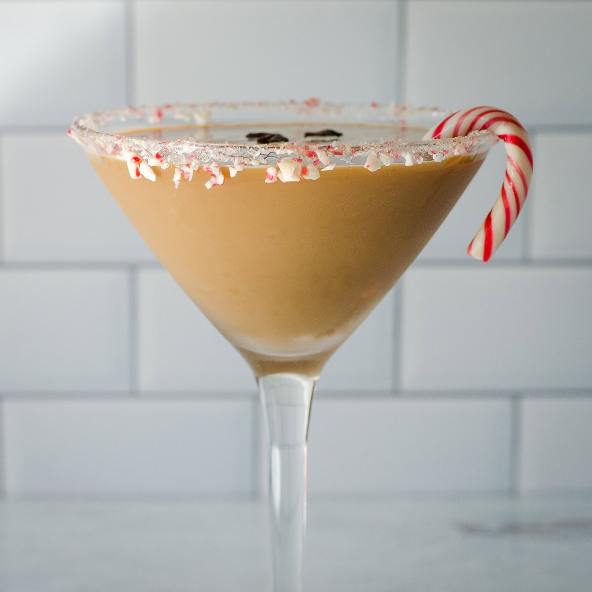 Peppermint espresso martini with a candy cane.