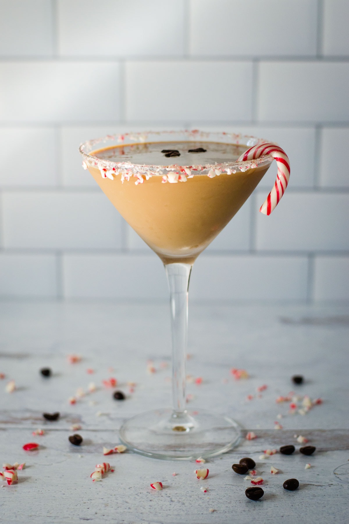 Peppermint espresso martini with a candy cane.