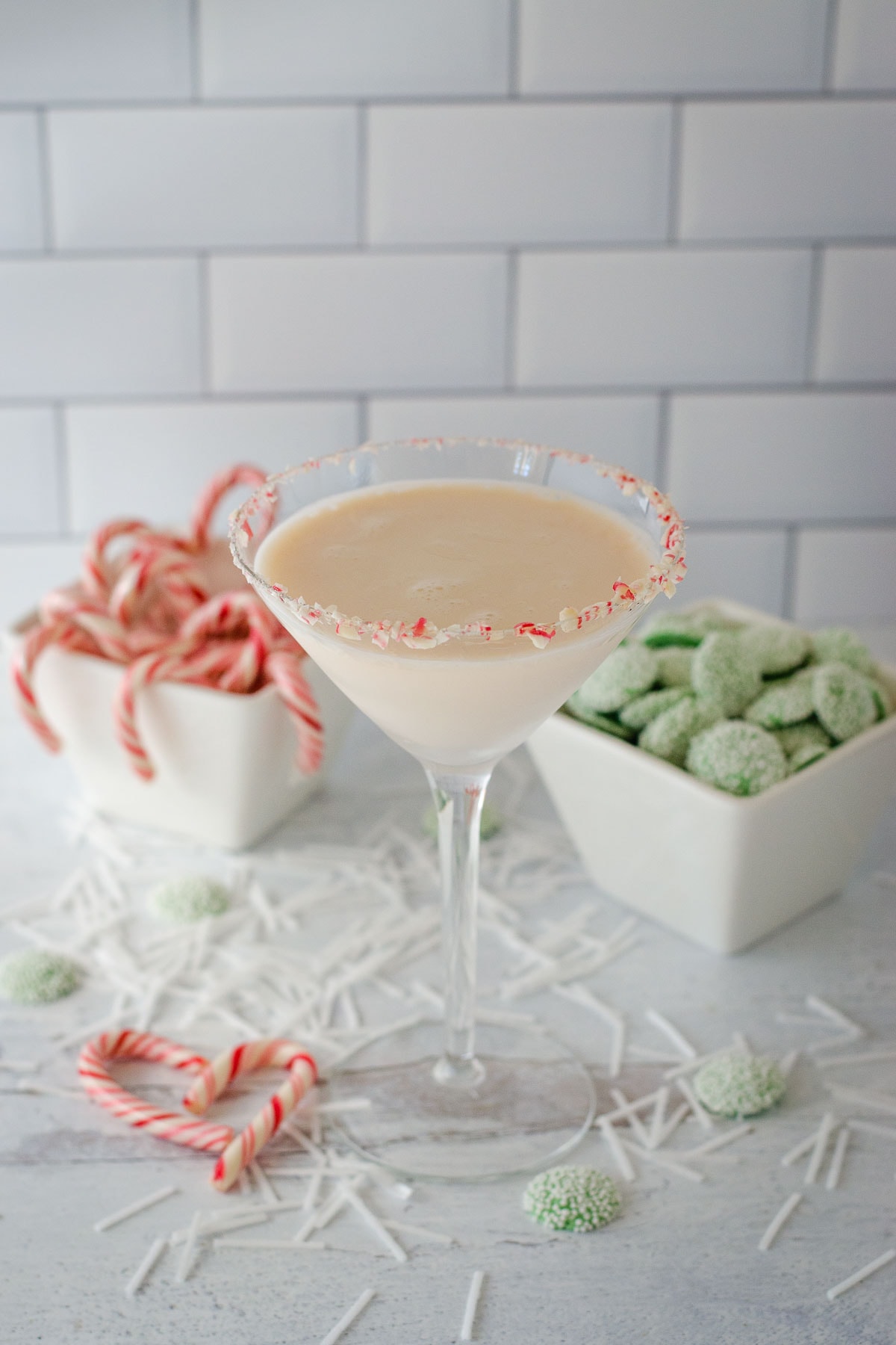 White chocolate peppermint martini with peppermint candies.