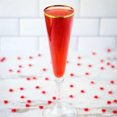 Valentines cocktail in flute with red hearts.