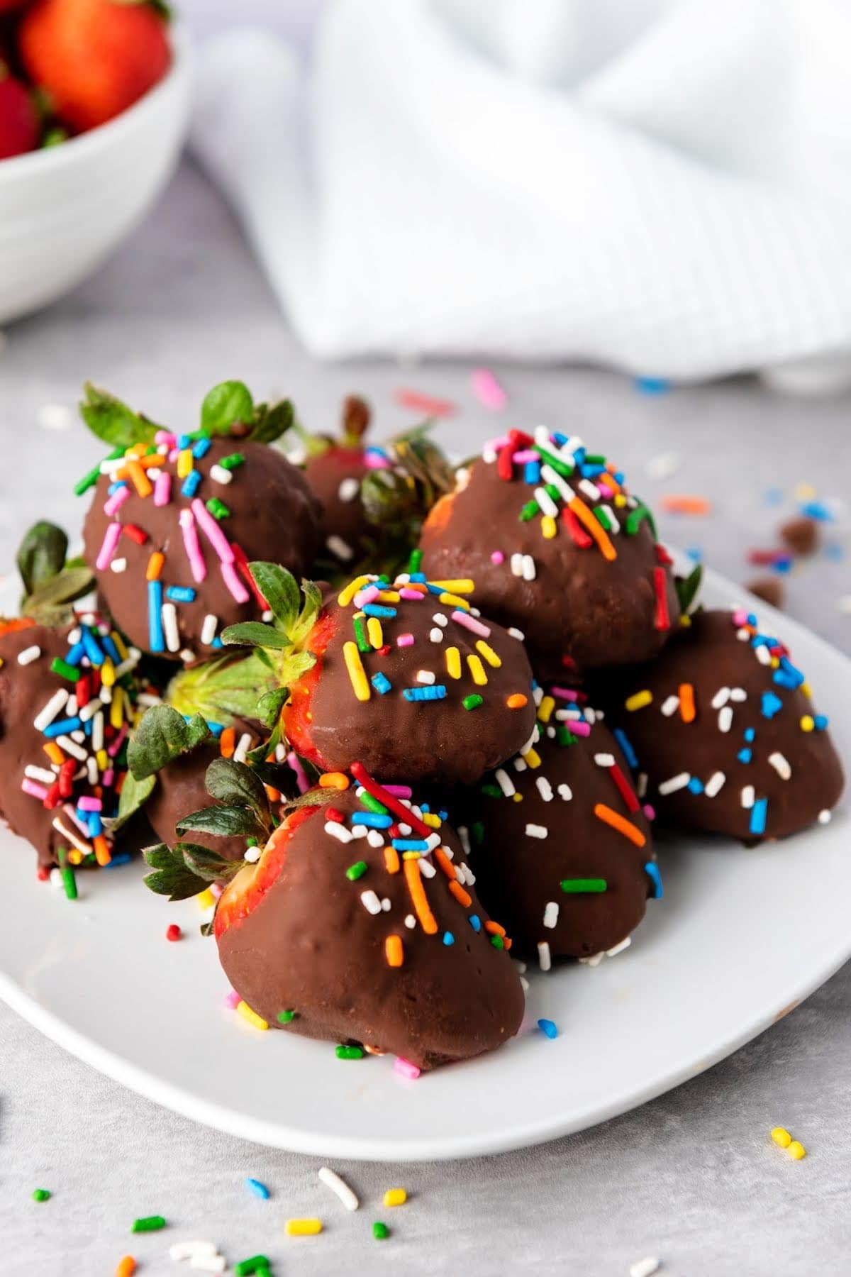 Chocolate covered strawberries with confetti sprinkles.