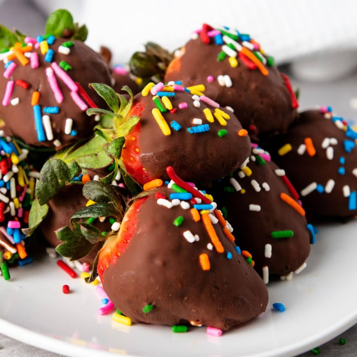 Chocolate covered strawberries with sprinkles.