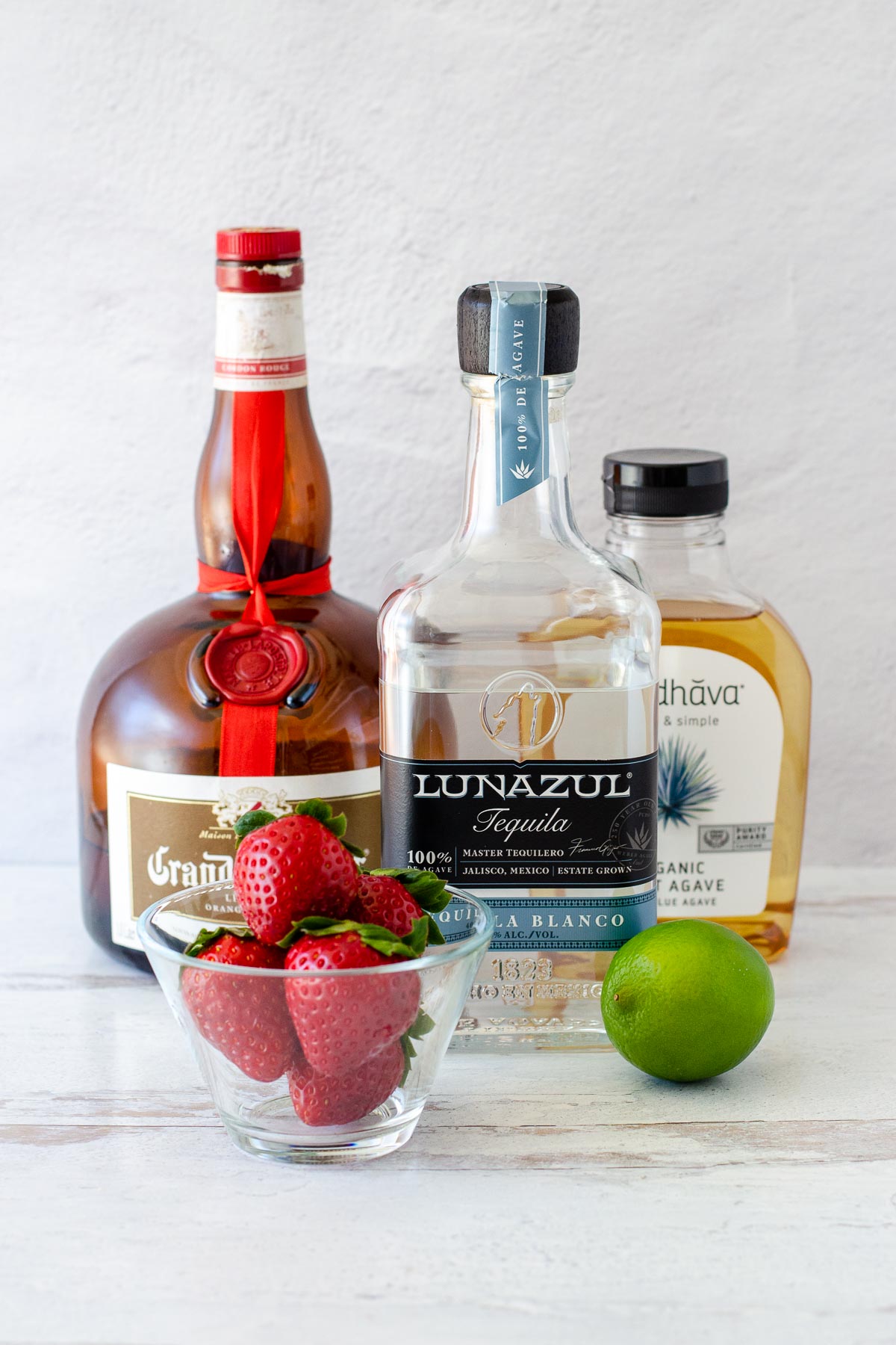 Grand Marnier, Lunazul Blanco Tequila, light agave, glass dish of strawberries, lime.