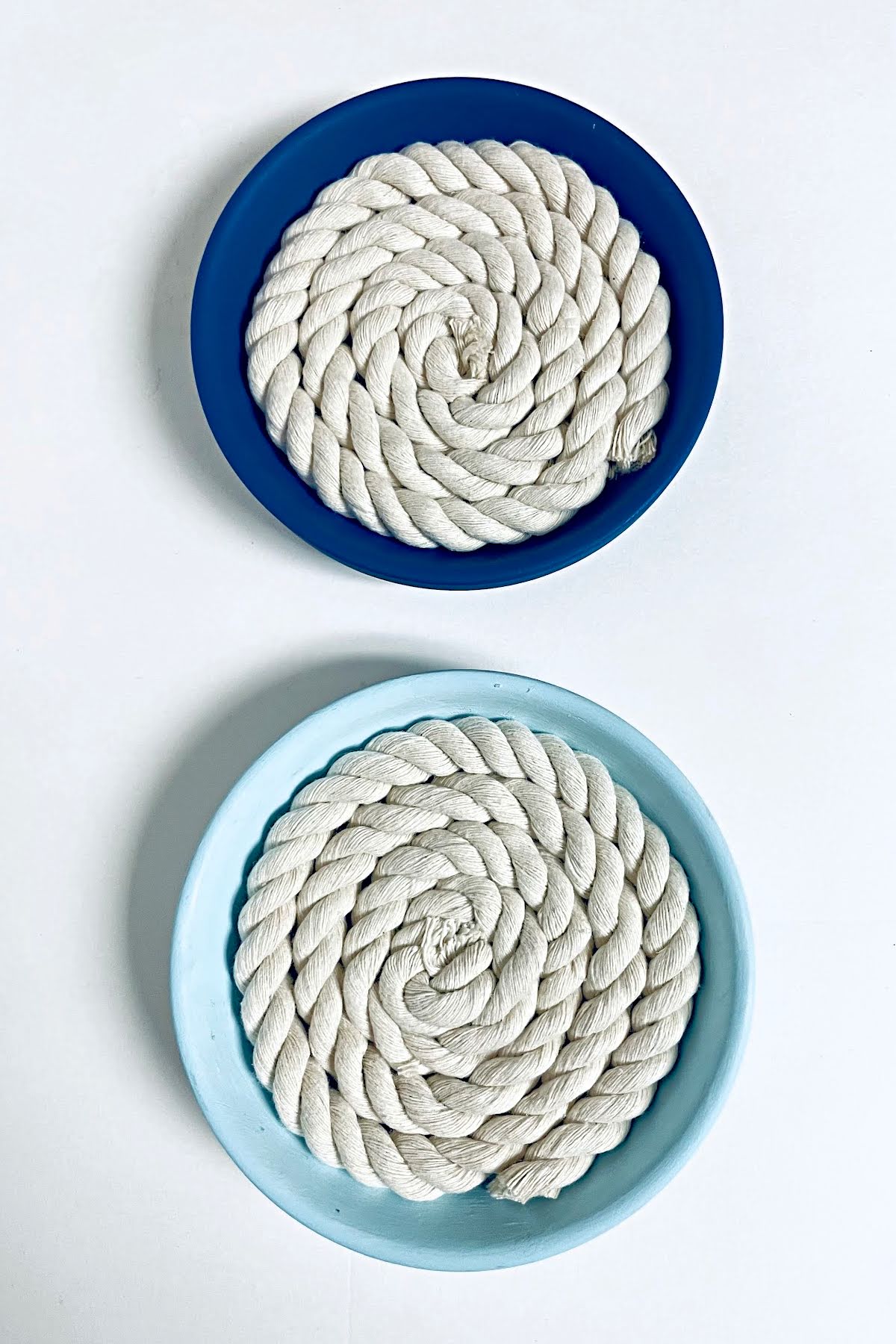 Completed dark blue and light blue rope coasters.