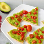 Christmas tree pita appetizers on white serving tray.