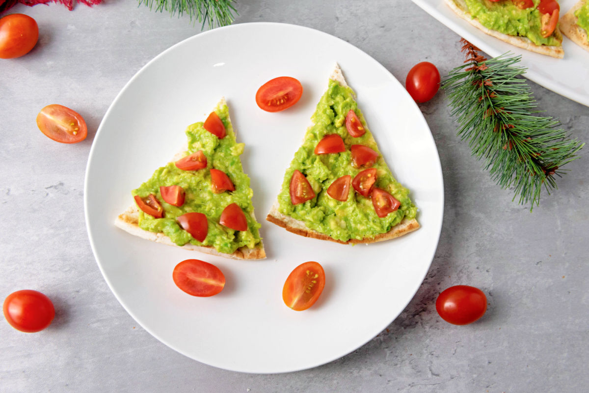 Christmas tree pita appetizers on white plate.