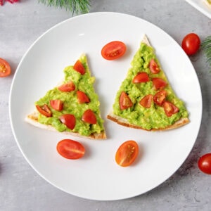 Christmas tree pita appetizers on white plate.