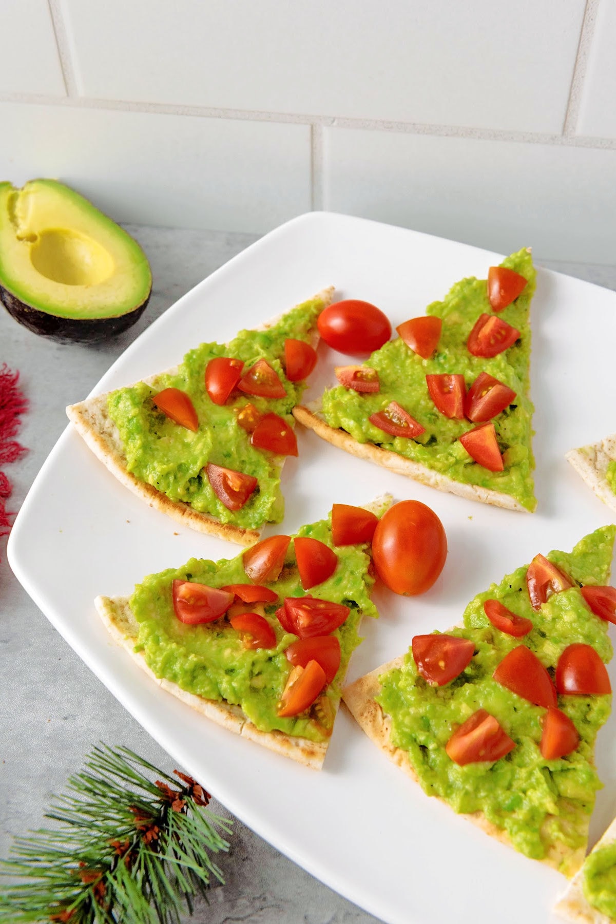 Christmas tree pita appetizers on white serving tray.
