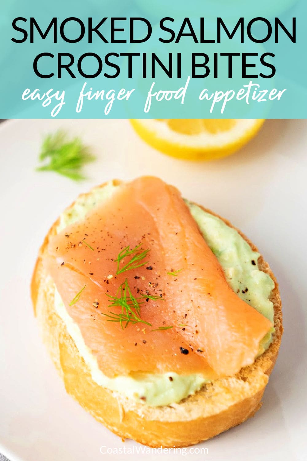 Smoked salmon crostini bite on white plate with dill and lemon.