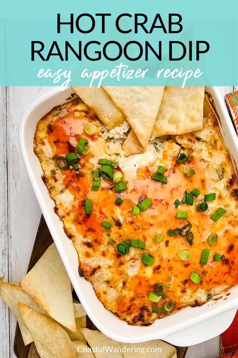 Hot crab rangoon dip with wonton chips in white baking dish.