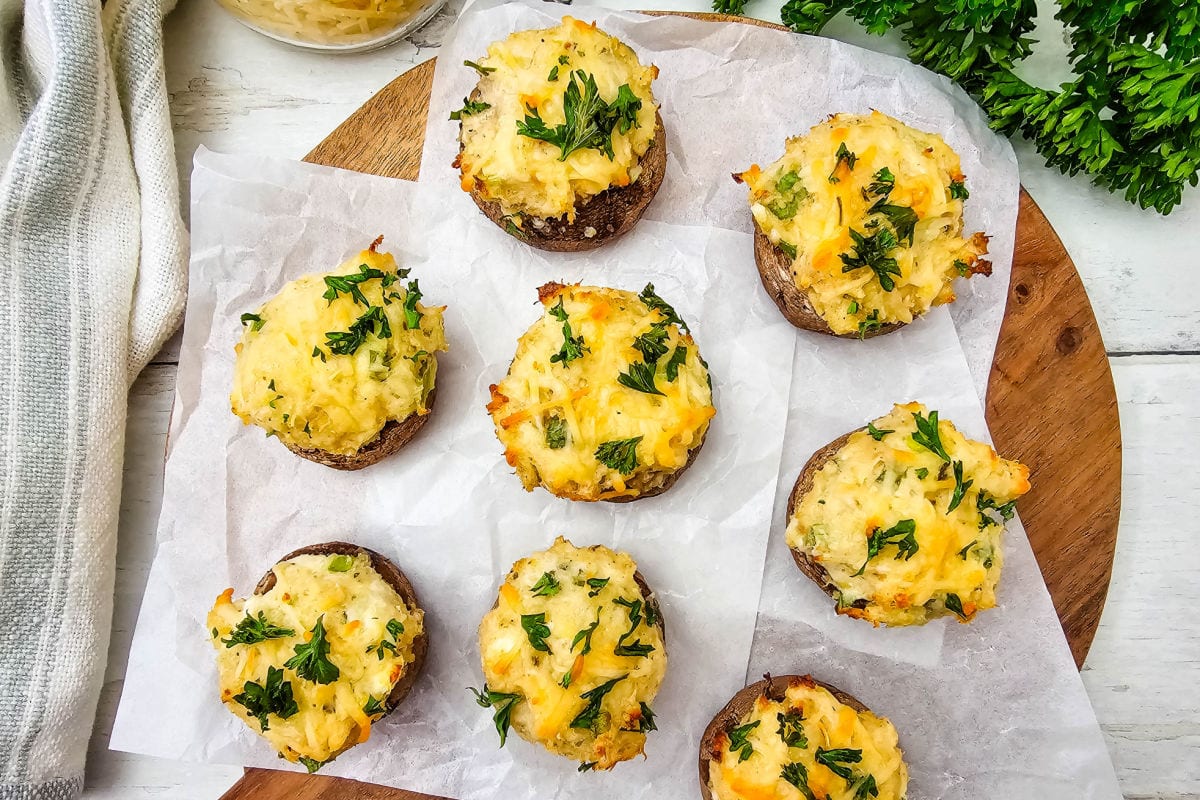 Baked crab stuffed mushrooms toped with cheese and parsley.