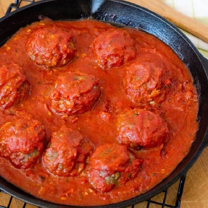Meatballs in red sauce in a cast iron skillet